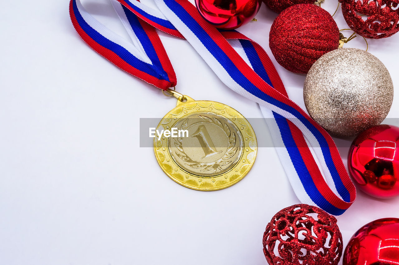 red, studio shot, no people, still life, indoors, medal, gold, celebration, food and drink, food, holiday, group of objects, high angle view, multi colored, decoration