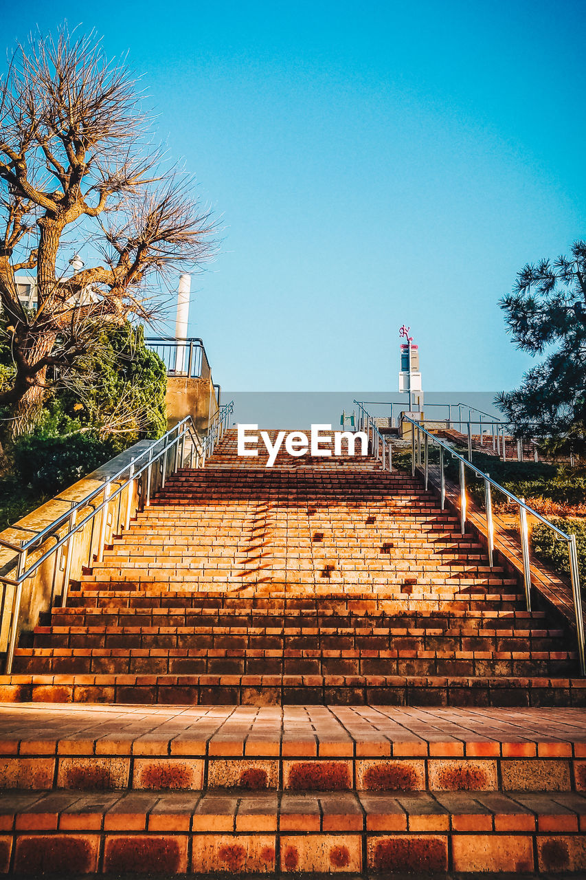 Steps against clear blue sky