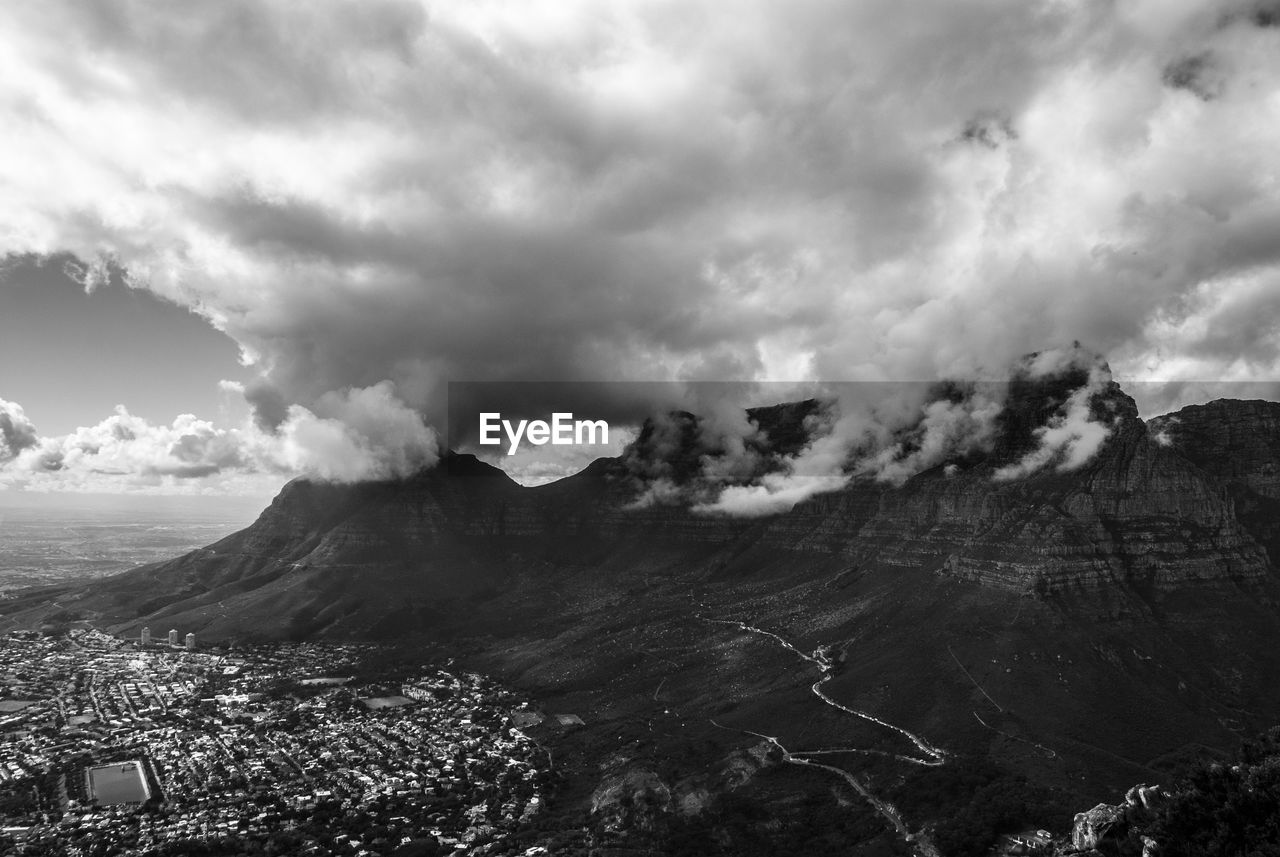 AERIAL VIEW OF MOUNTAIN AGAINST CLOUDY SKY