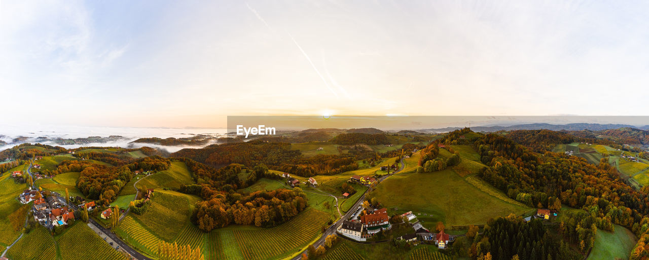 HIGH ANGLE VIEW OF FIELD AGAINST SKY DURING SUNSET