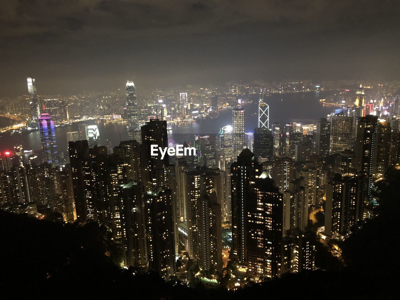 High angle view of illuminated cityscape against sky at night