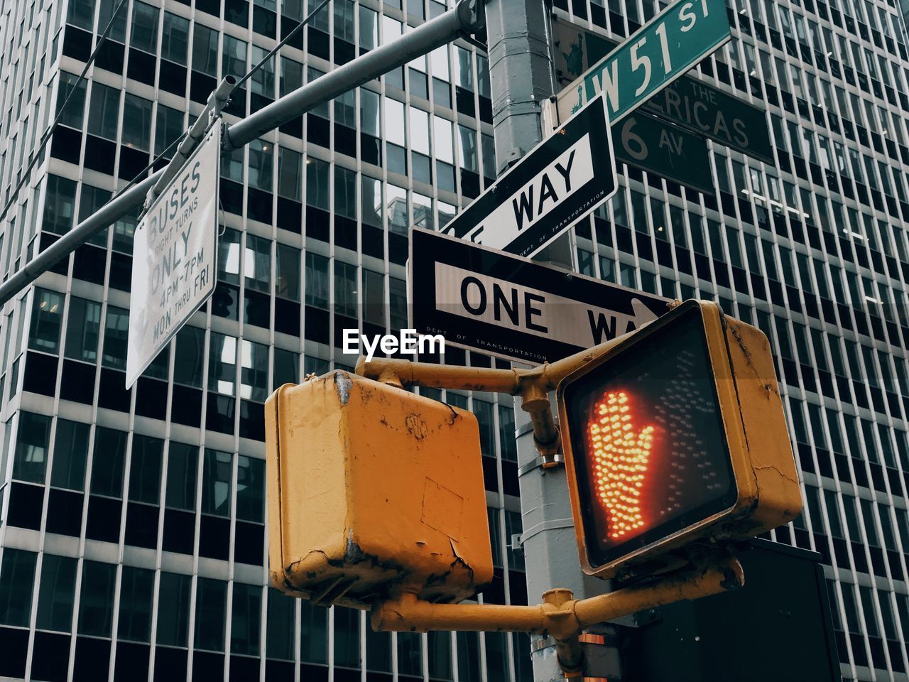 Low angle view of road sign against building