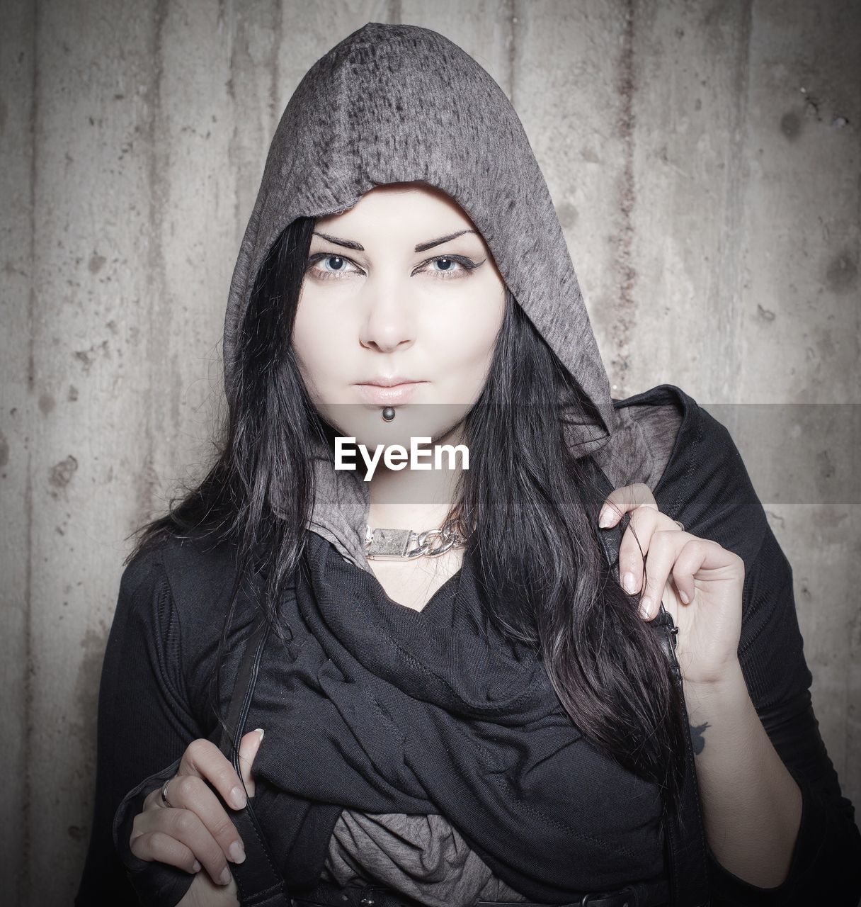 Portrait of beautiful young woman wearing hooded shirt