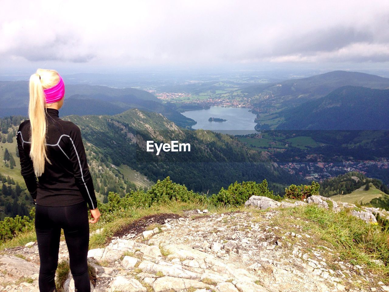 Rear view of female hiker looking at river while standing on mountain