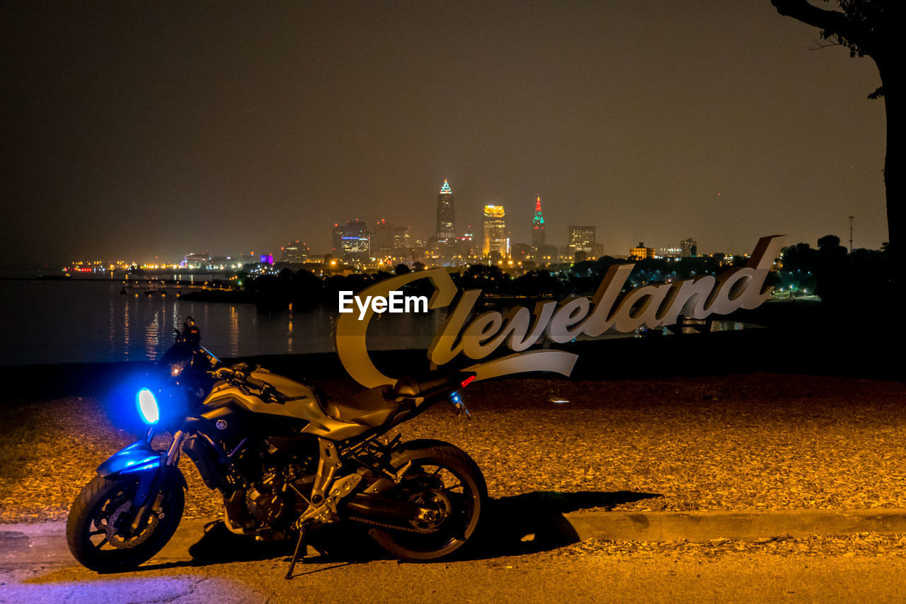 VIEW OF ILLUMINATED CITY AT NIGHT