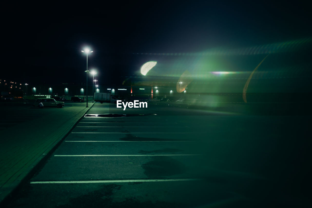 light, night, illuminated, darkness, transportation, lighting, lighting equipment, road, street, green, street light, city, mode of transportation, architecture, no people, light - natural phenomenon, sign, dark, nature, outdoors, car, road marking, motor vehicle, marking