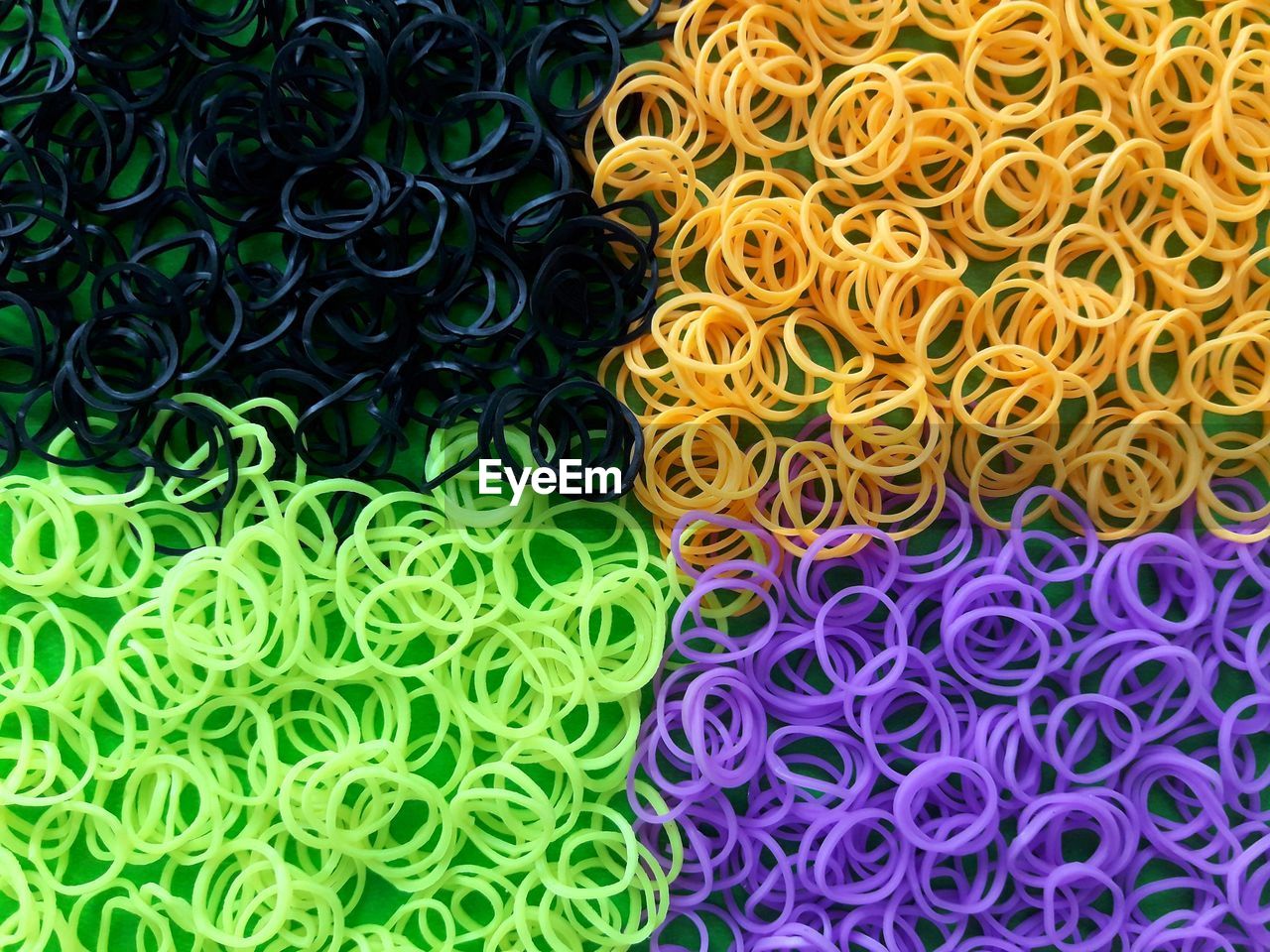 Full frame shot of multi colored rubber bands on table for sale