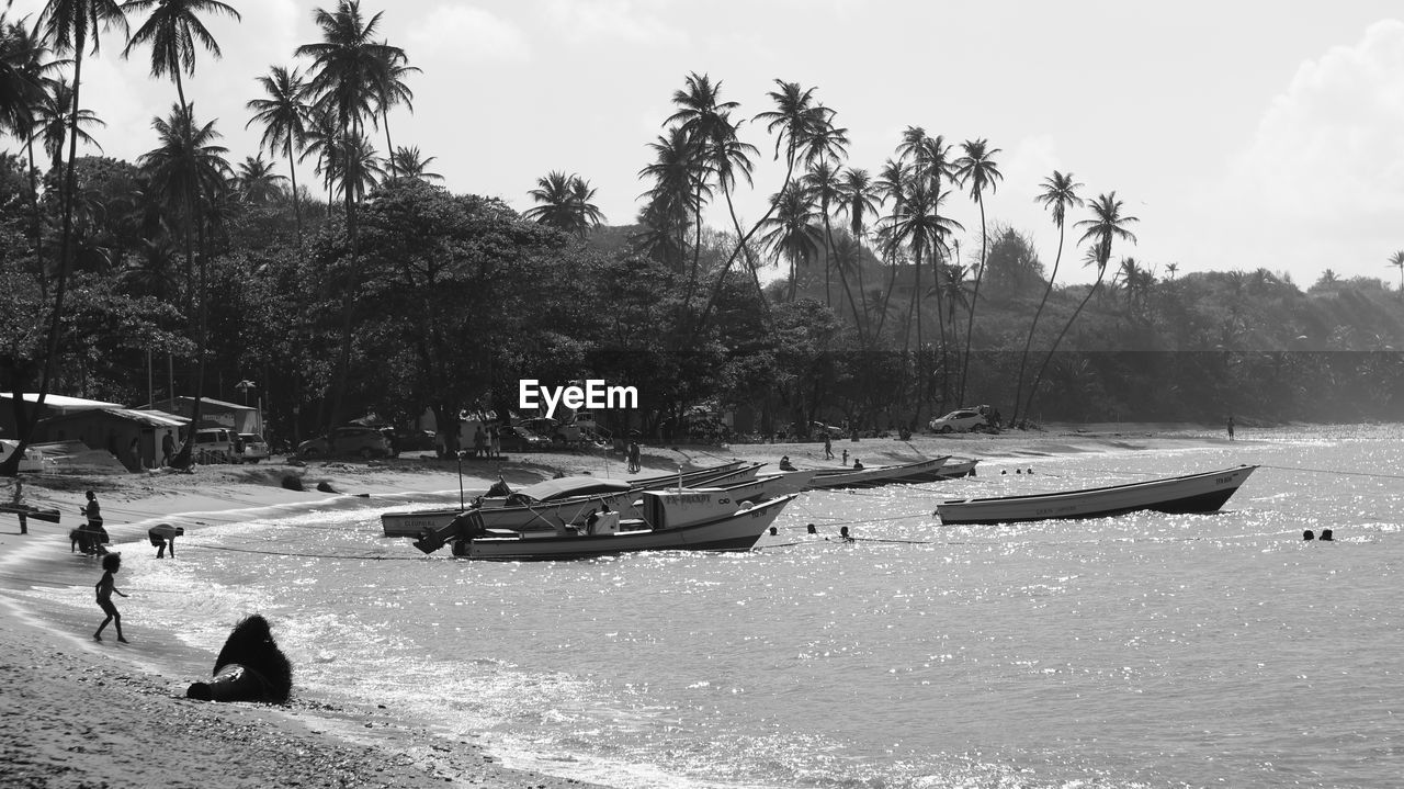 PEOPLE SITTING ON BEACH