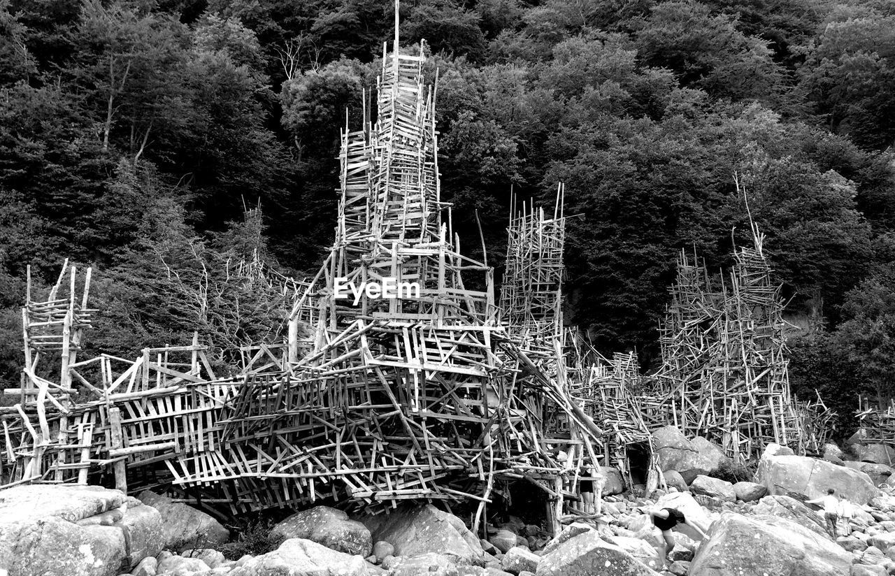 Built structure on rocks against trees