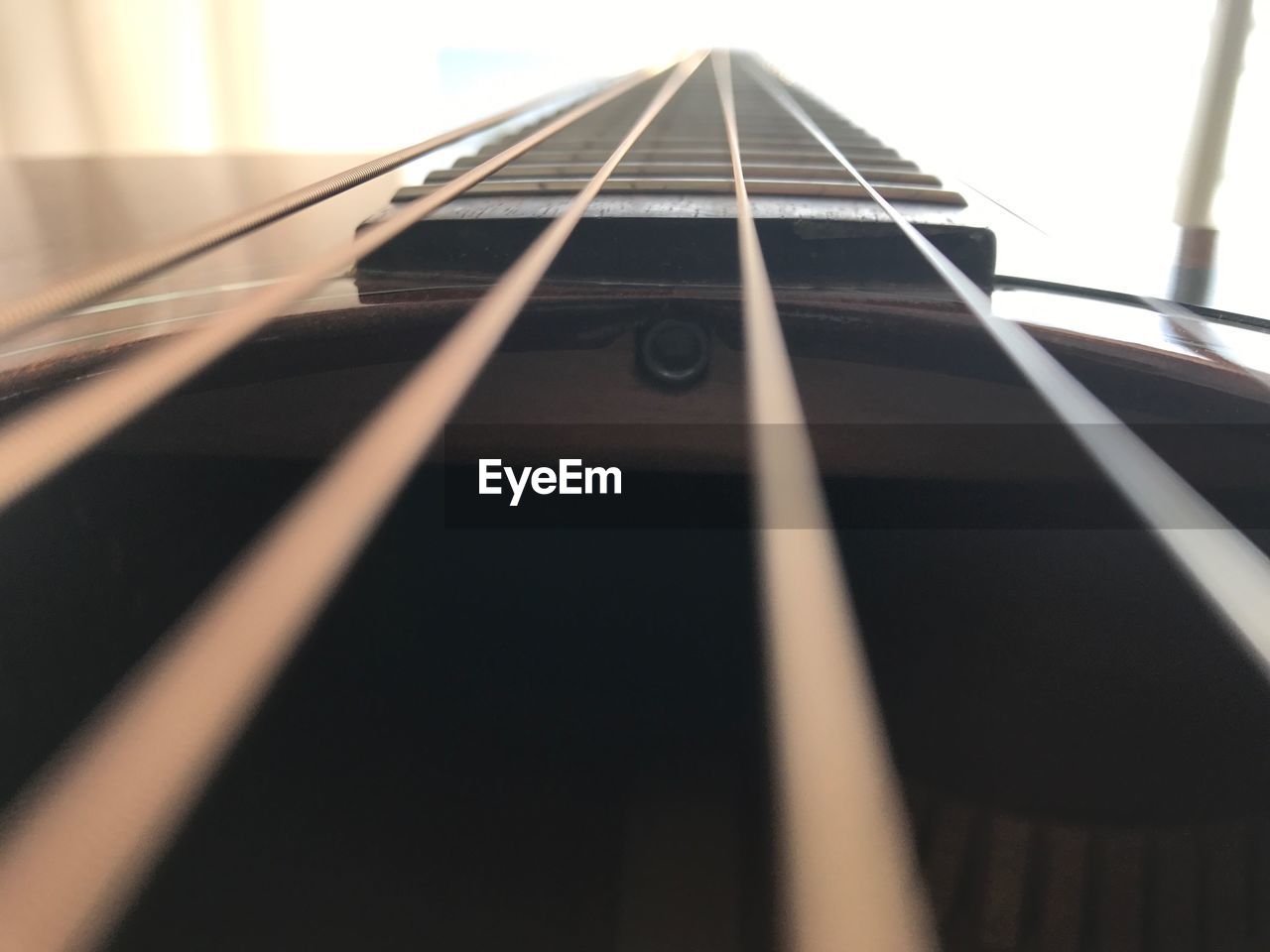 CLOSE-UP OF GUITAR ON THE FLOOR