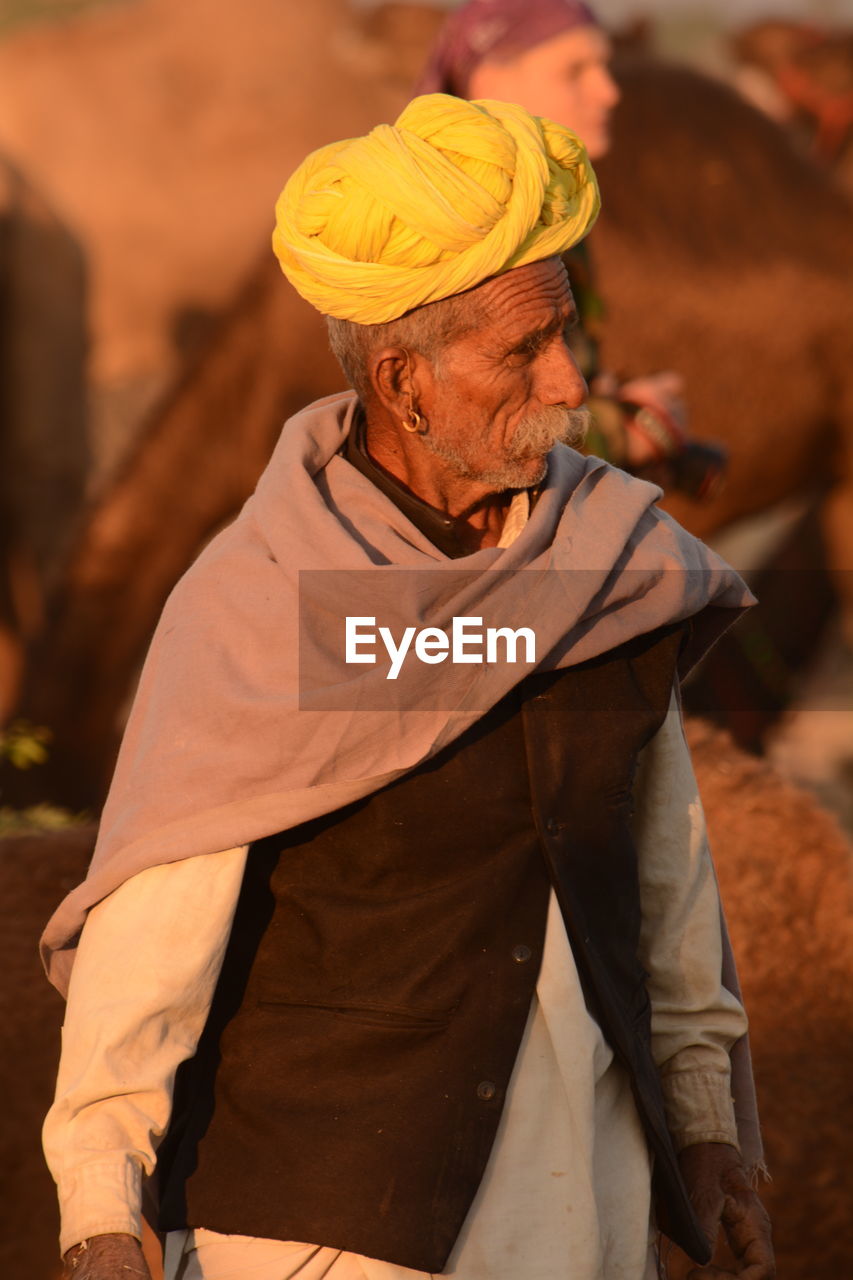 Senior man wearing turban looking away