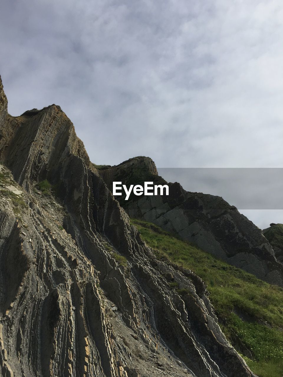 LOW ANGLE VIEW OF ROCK FORMATION AGAINST SKY