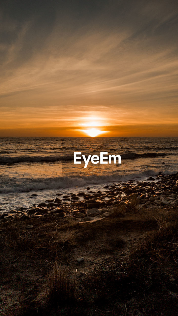 Scenic view of sea against sky at sunset