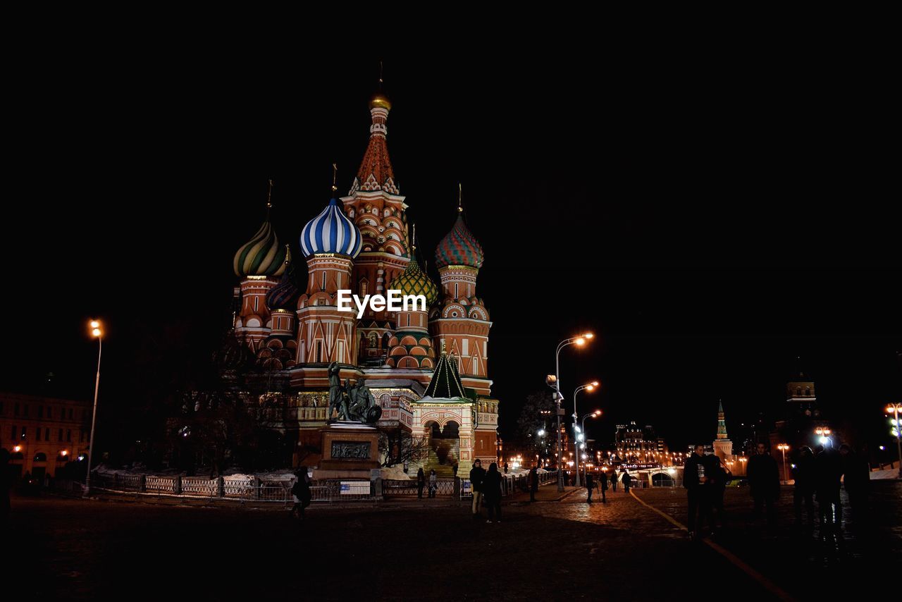 VIEW OF ILLUMINATED CLOCK TOWER AT NIGHT