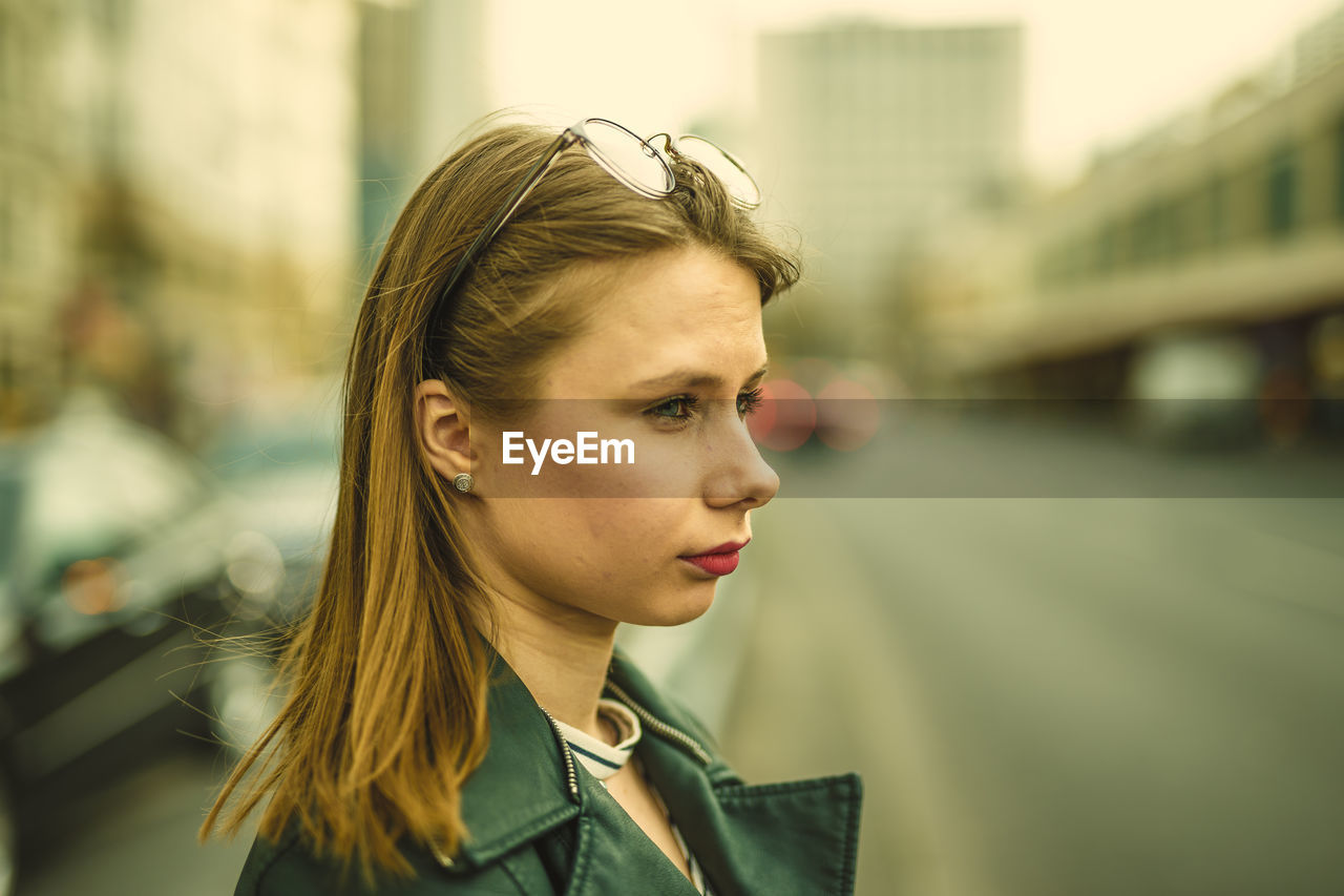 Close-up of thoughtful young woman on street