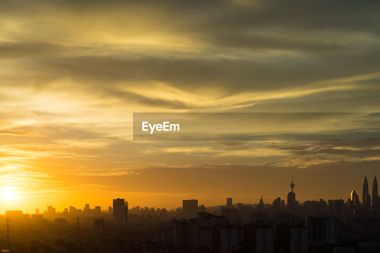 Cityscape against sky during sunset