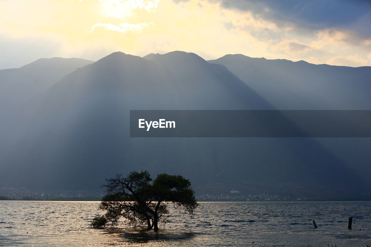 Scenic view of calm sea against cloudy sky