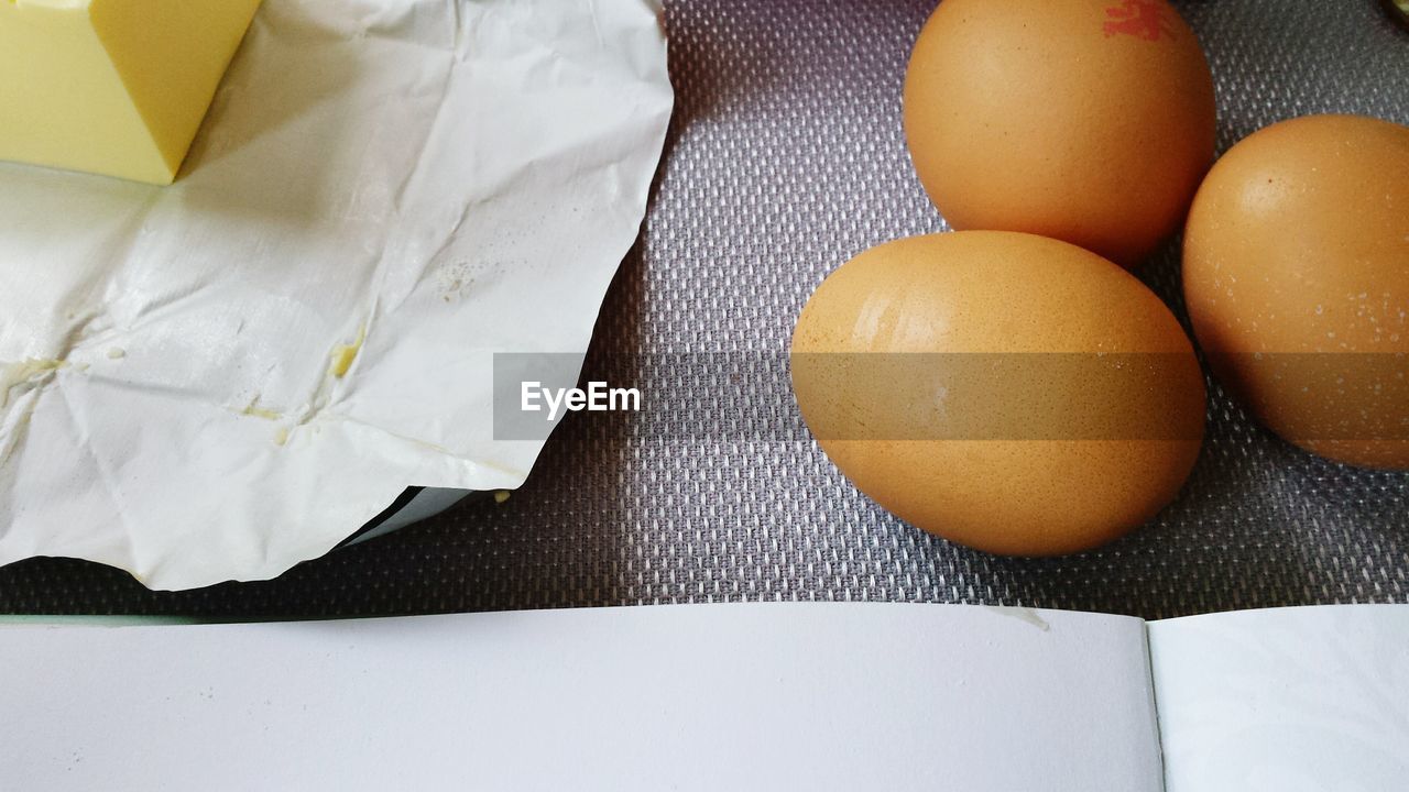 High angle view of eggs and butter on table