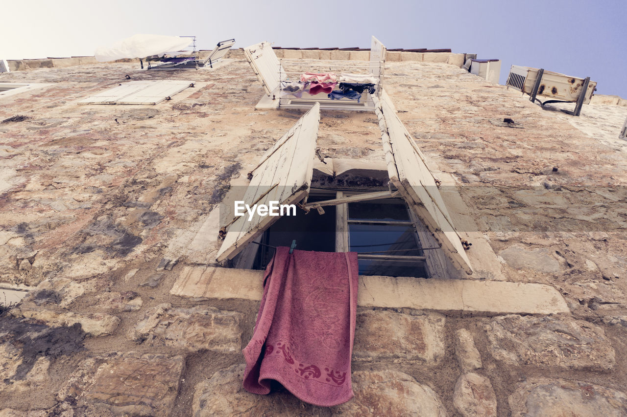 Towel hanging from old building window