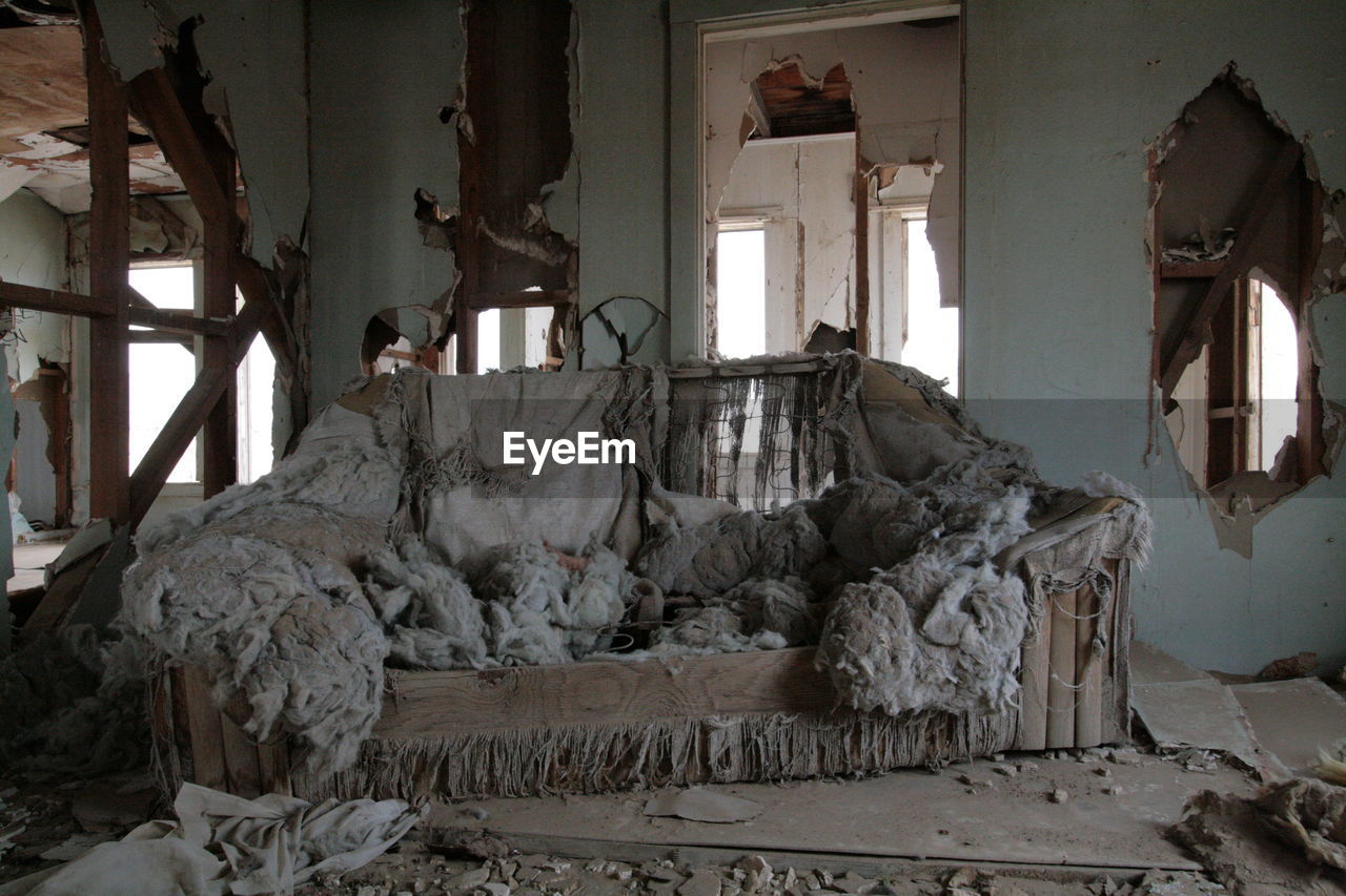 Messy sofa in abandoned house
