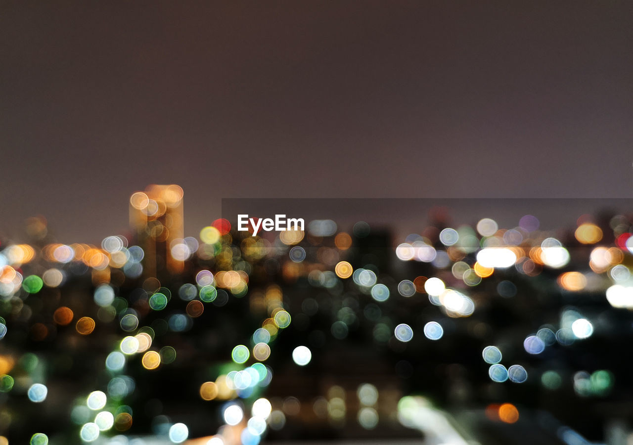 Defocused image of illuminated city at night