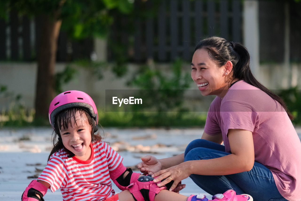 Side view of mother and daughter in park