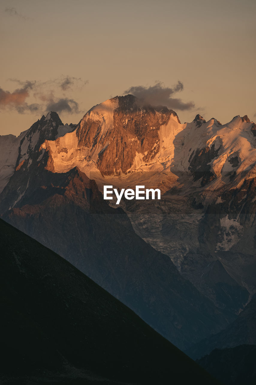 Scenic view of mountain range against sky during sunset