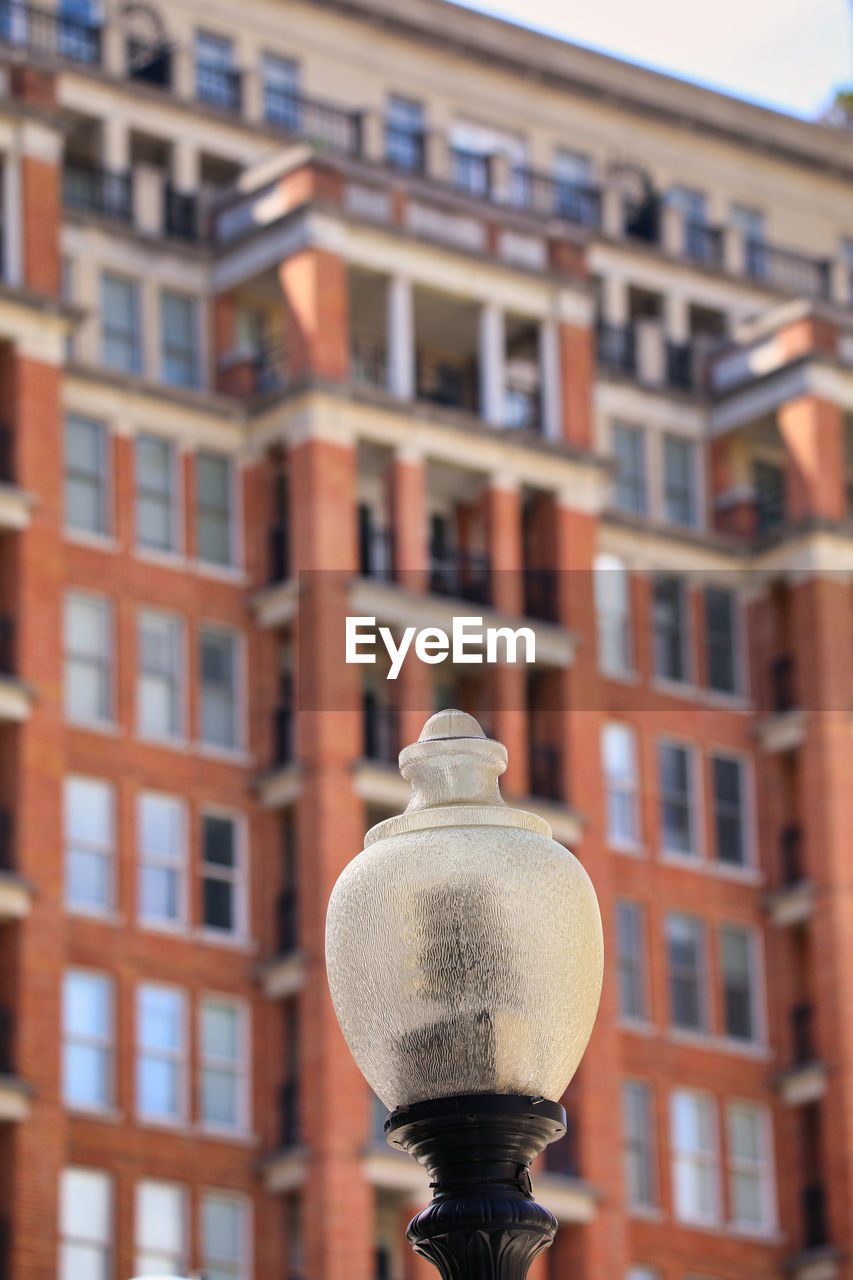 Low angle view of street light against building