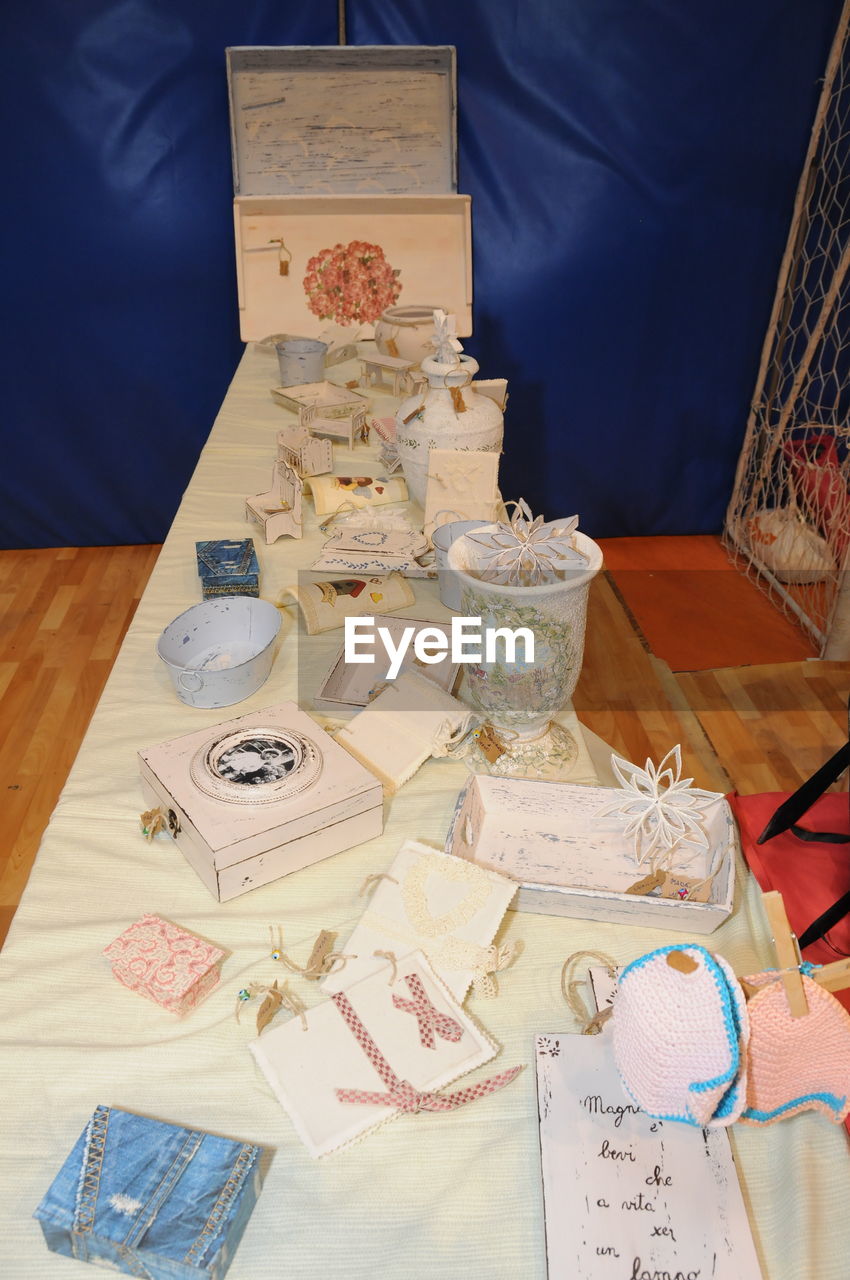 CLOSE-UP OF PAPER AND TABLE ON FLOOR