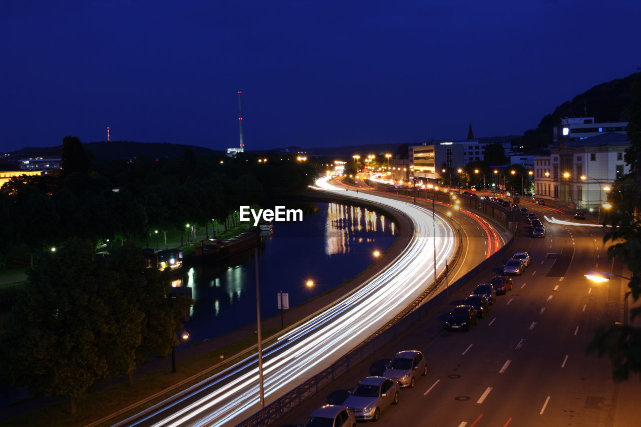 HIGH ANGLE VIEW OF LIGHT TRAILS ON ROAD