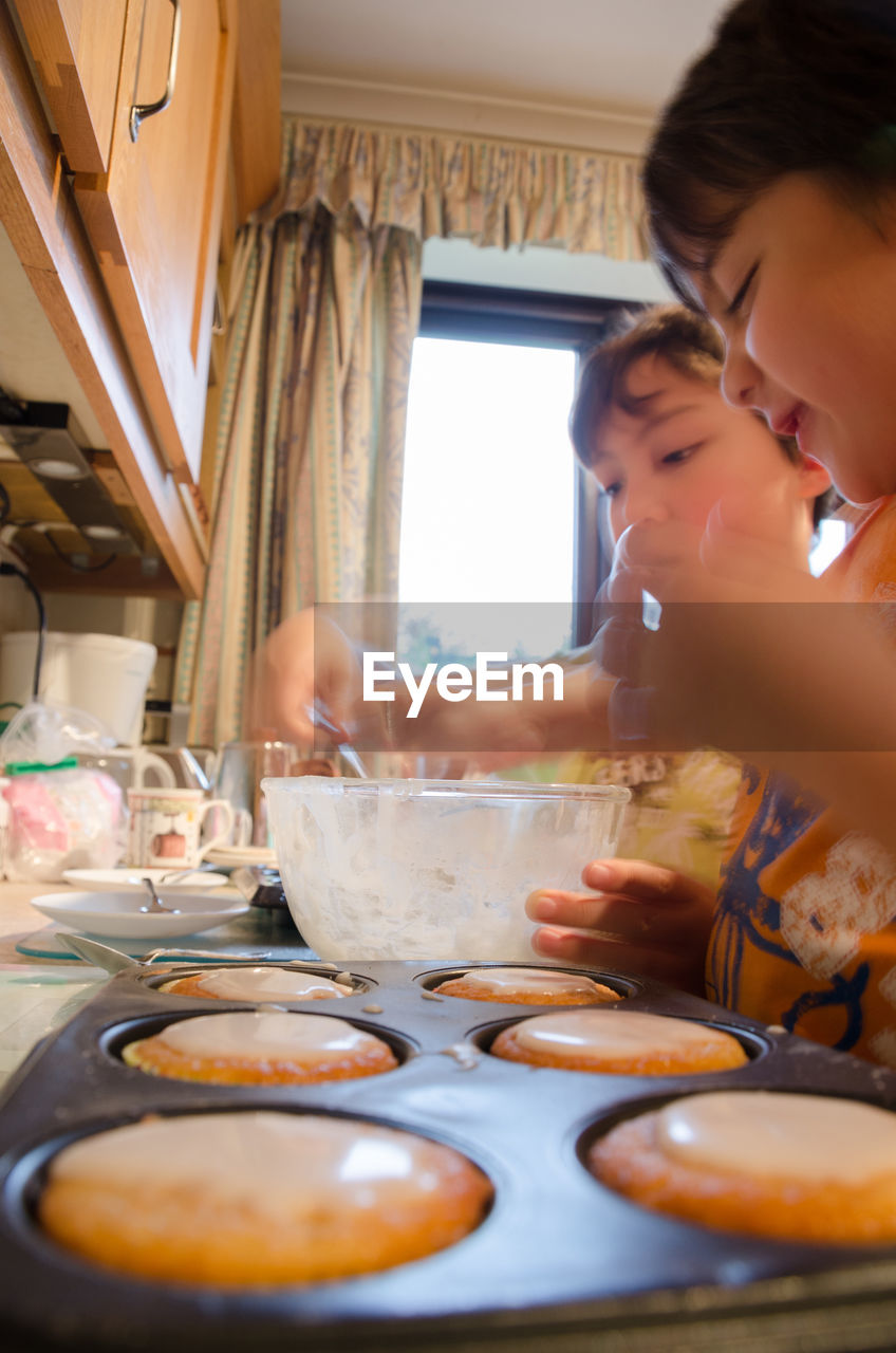 Close-up of girls preparing sweet food at home