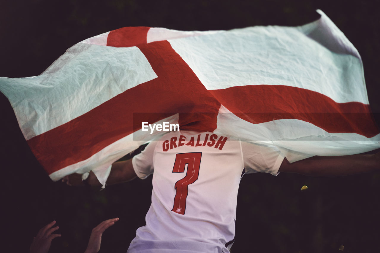 Rear view of football fan with england flag