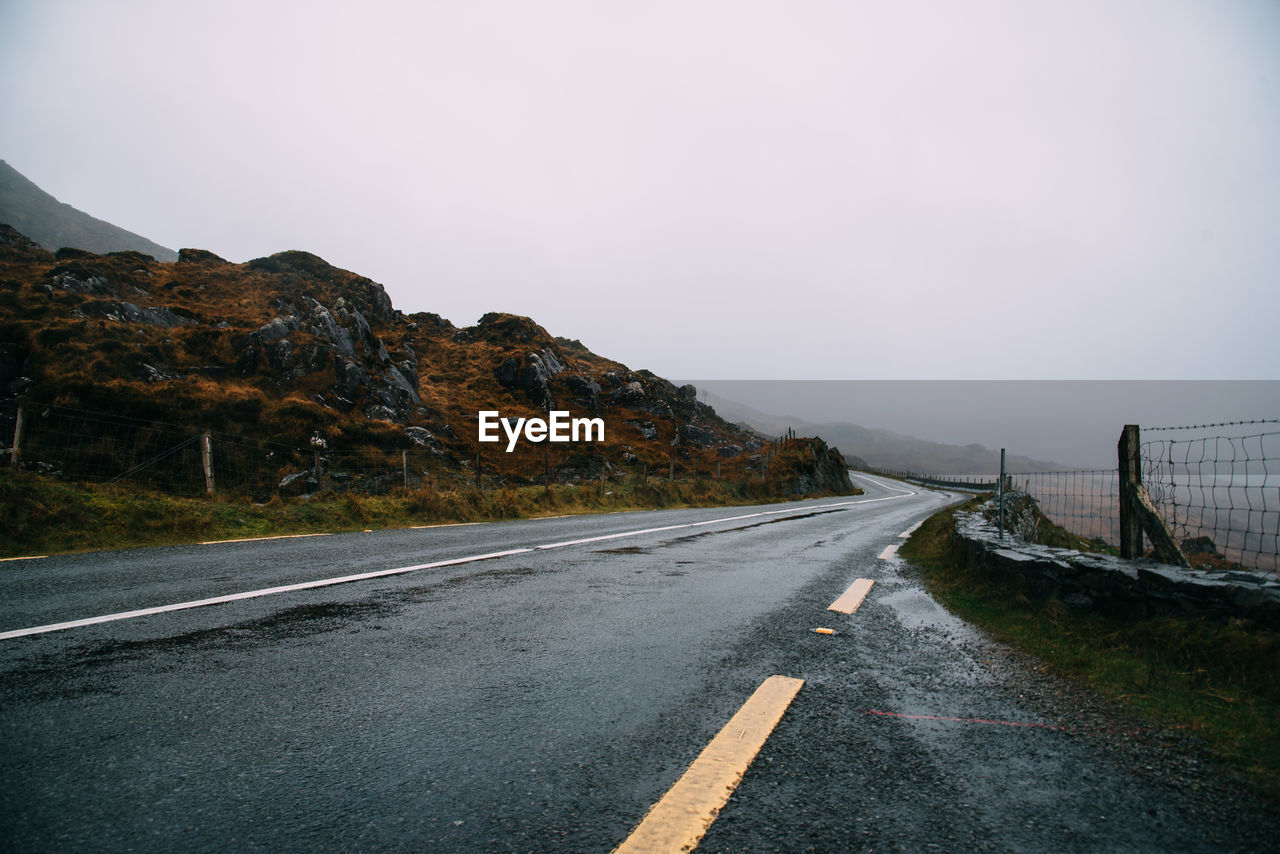 Misty lonely road in the wild atlantic way of ireland