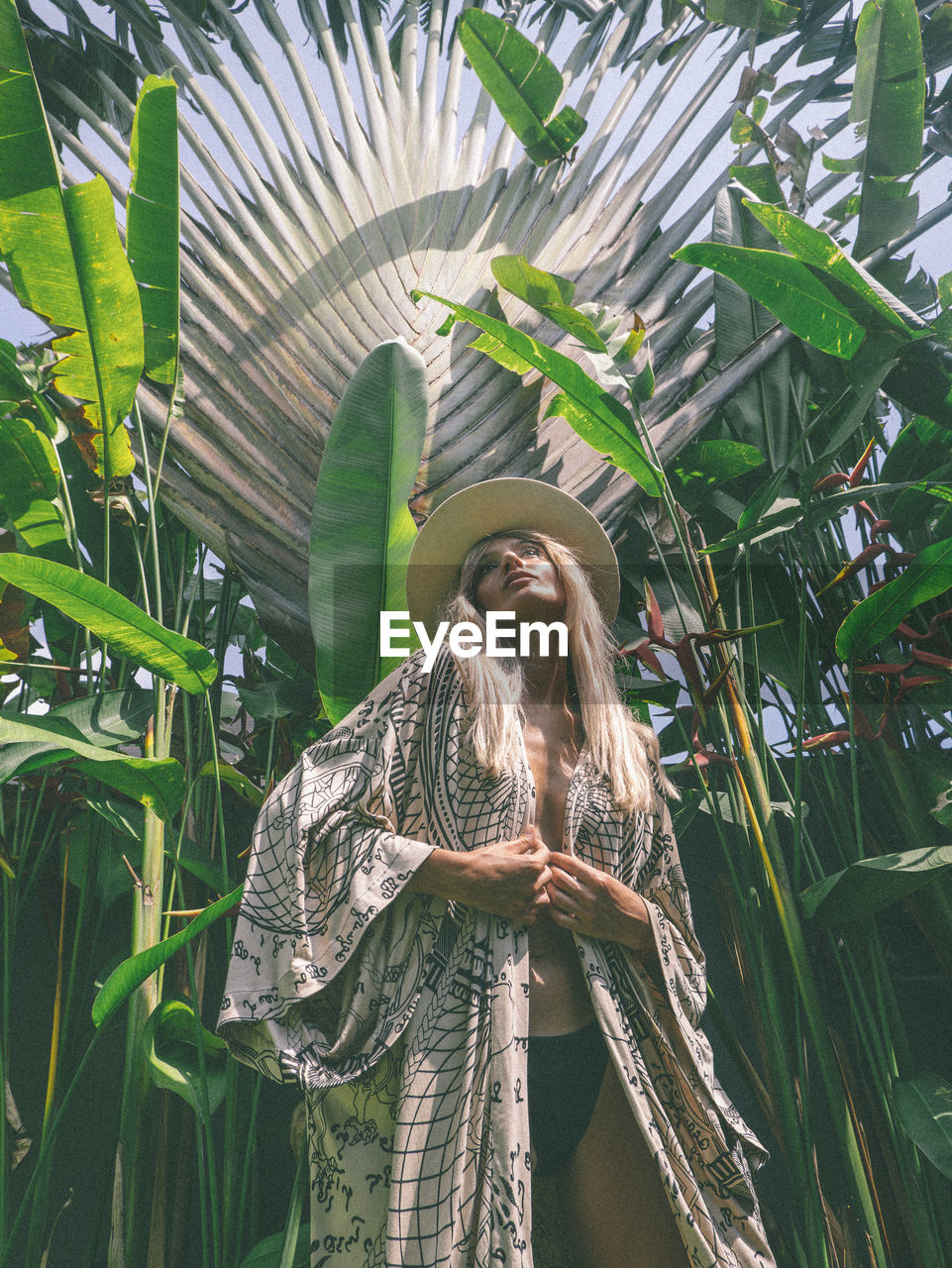 Rear view of woman standing by plants