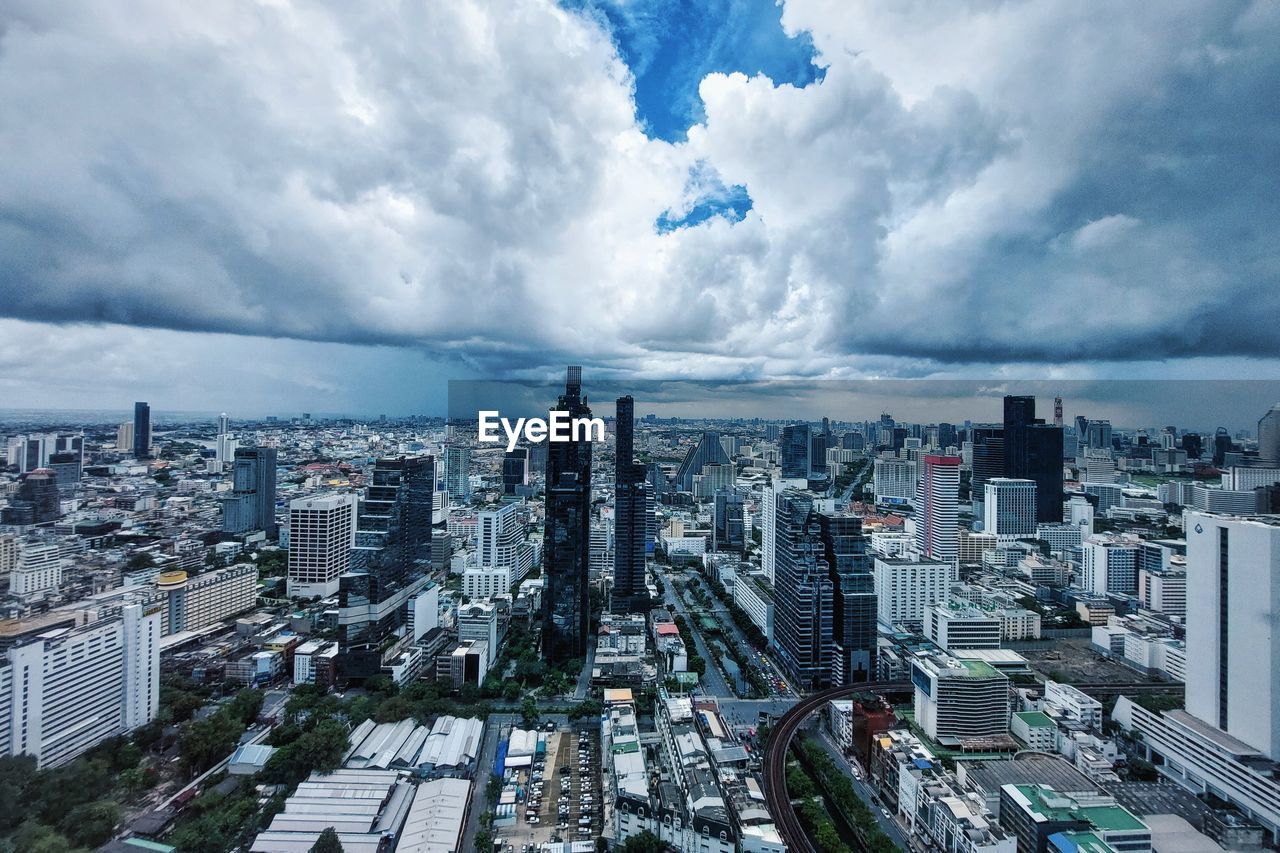 High angle view of city buildings against sky