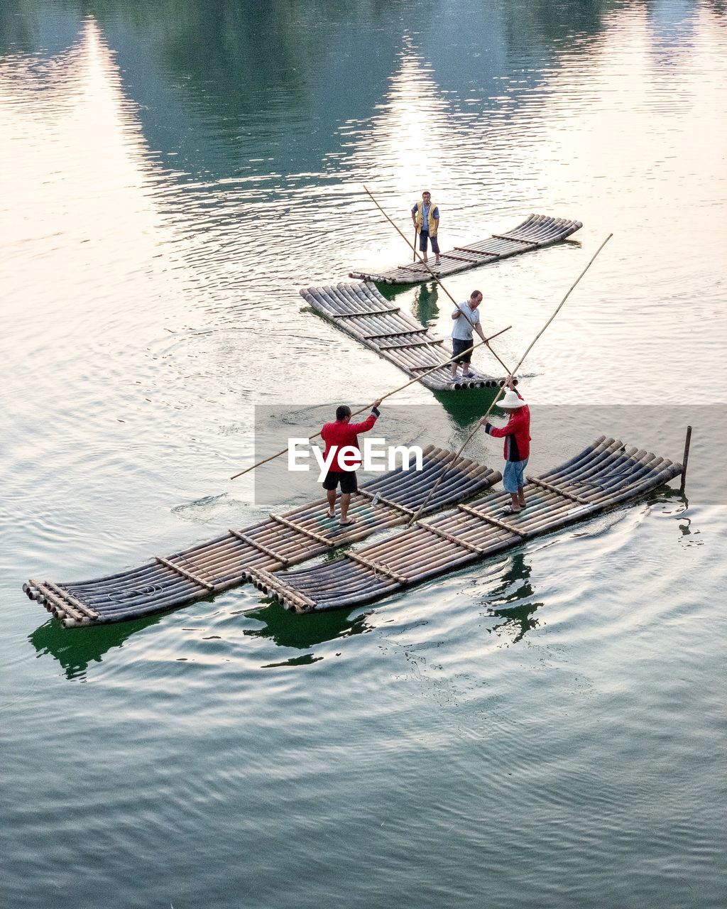 HIGH ANGLE VIEW OF PEOPLE ON BOAT AT LAKE