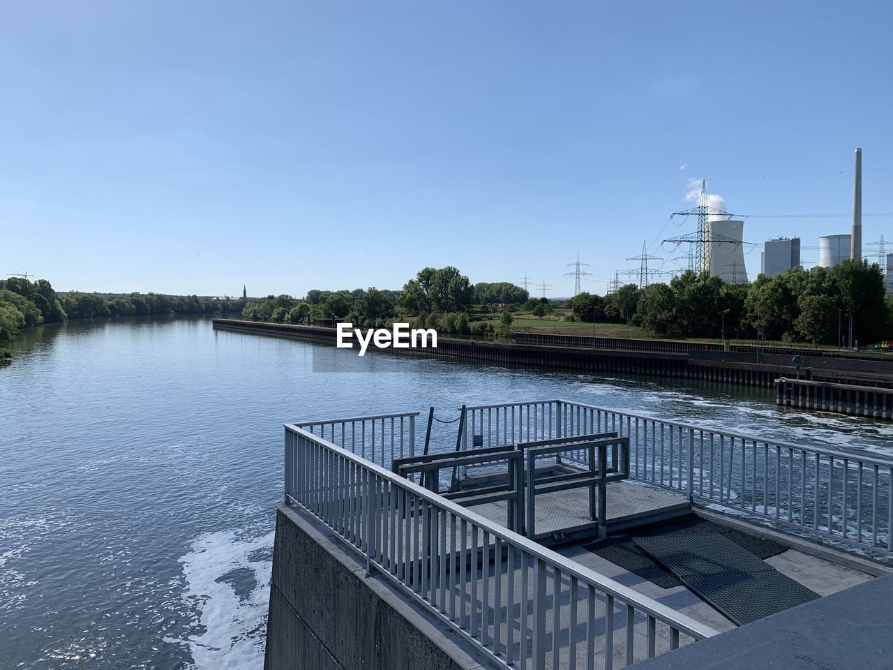 VIEW OF BRIDGE OVER RIVER AGAINST CLEAR BLUE SKY