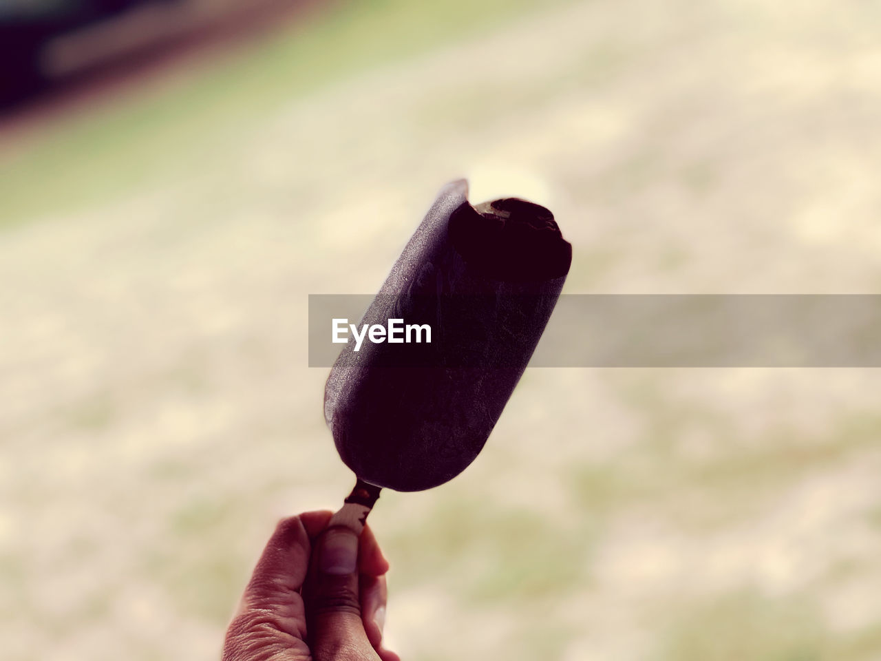 cropped hand of person holding ice cream