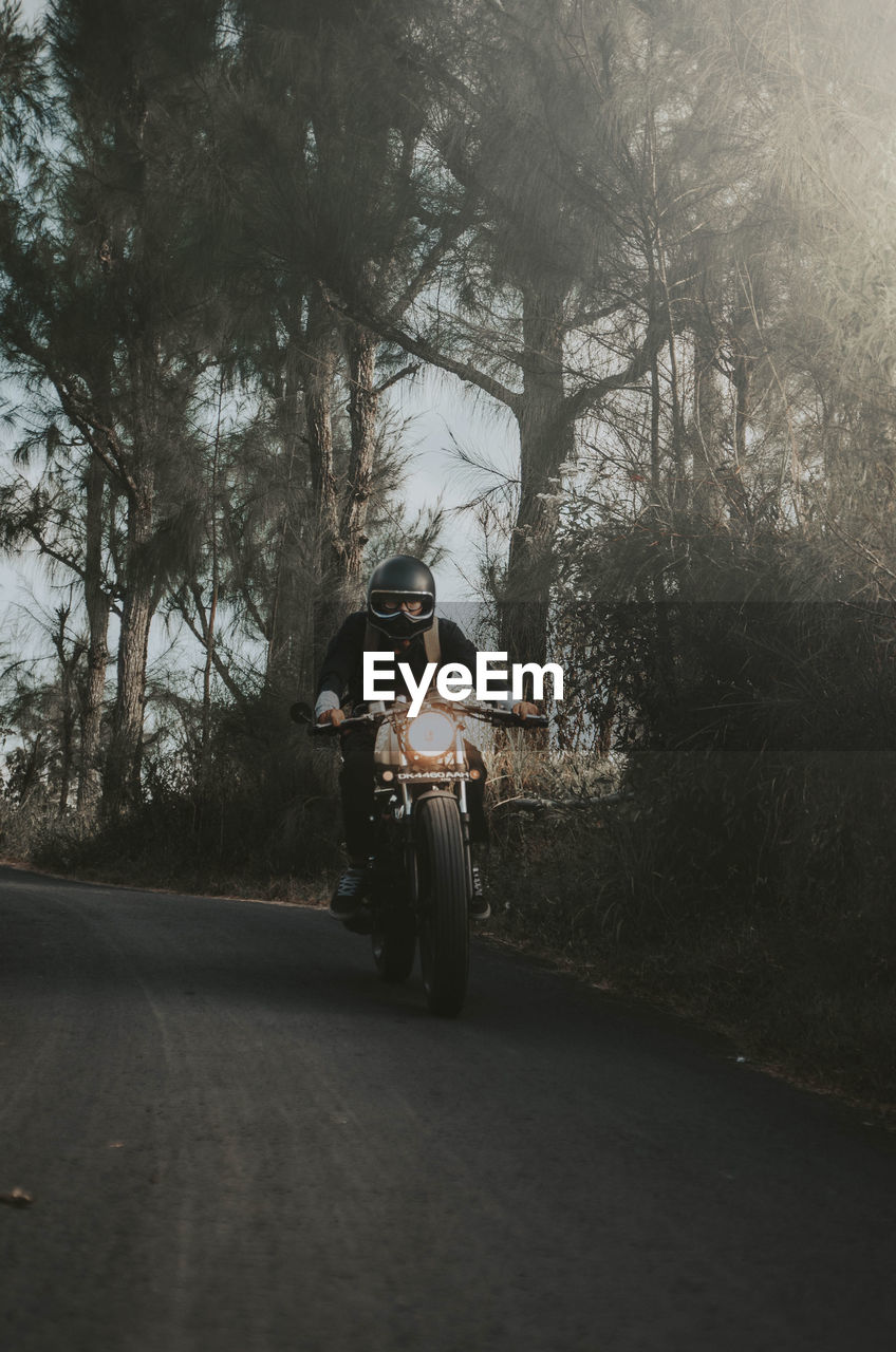 MAN RIDING BICYCLE ON ROAD