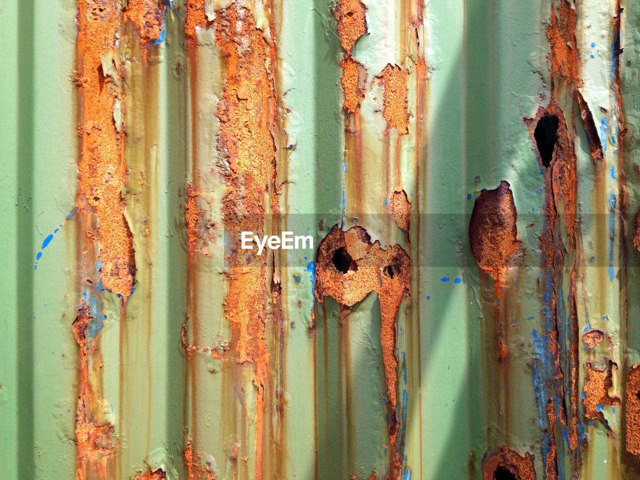 Full frame shot of peeled off rusty corrugated iron