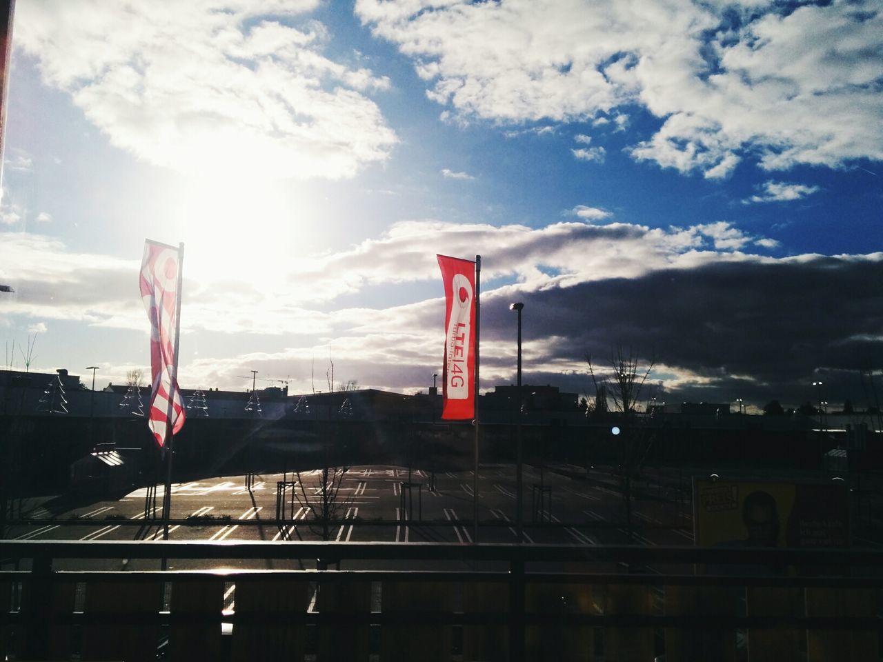 INDUSTRIAL BUILDINGS AGAINST CLOUDY SKY