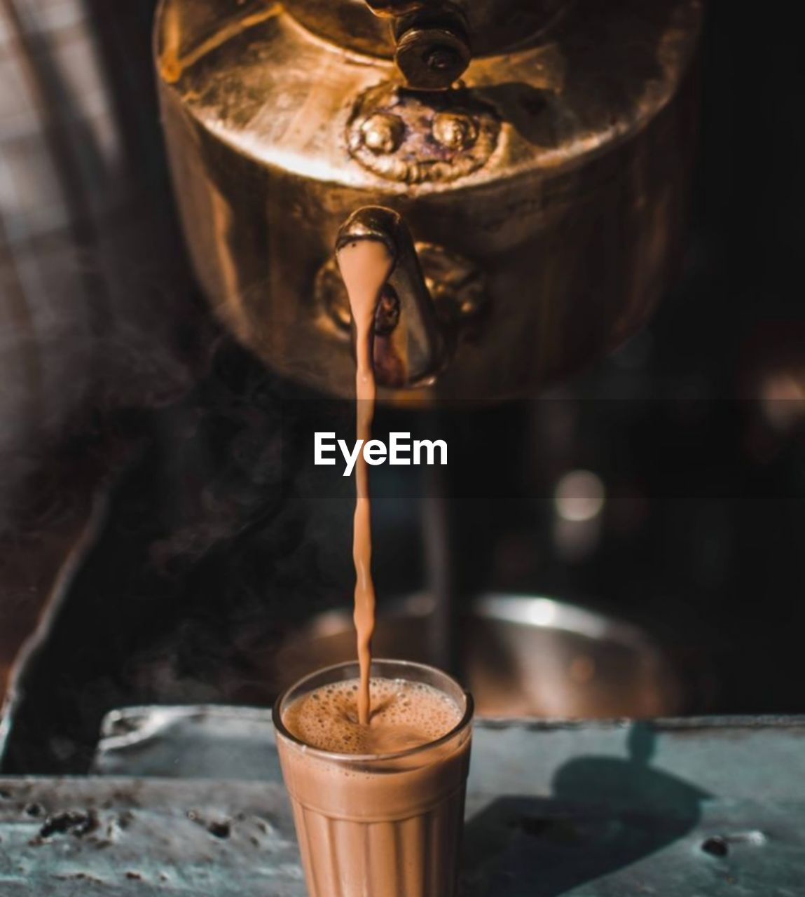 Close-up of coffee pouring in glass