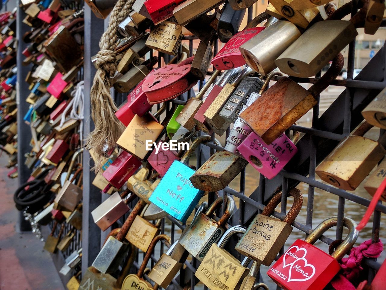 Close-up of padlocks hanging on railing