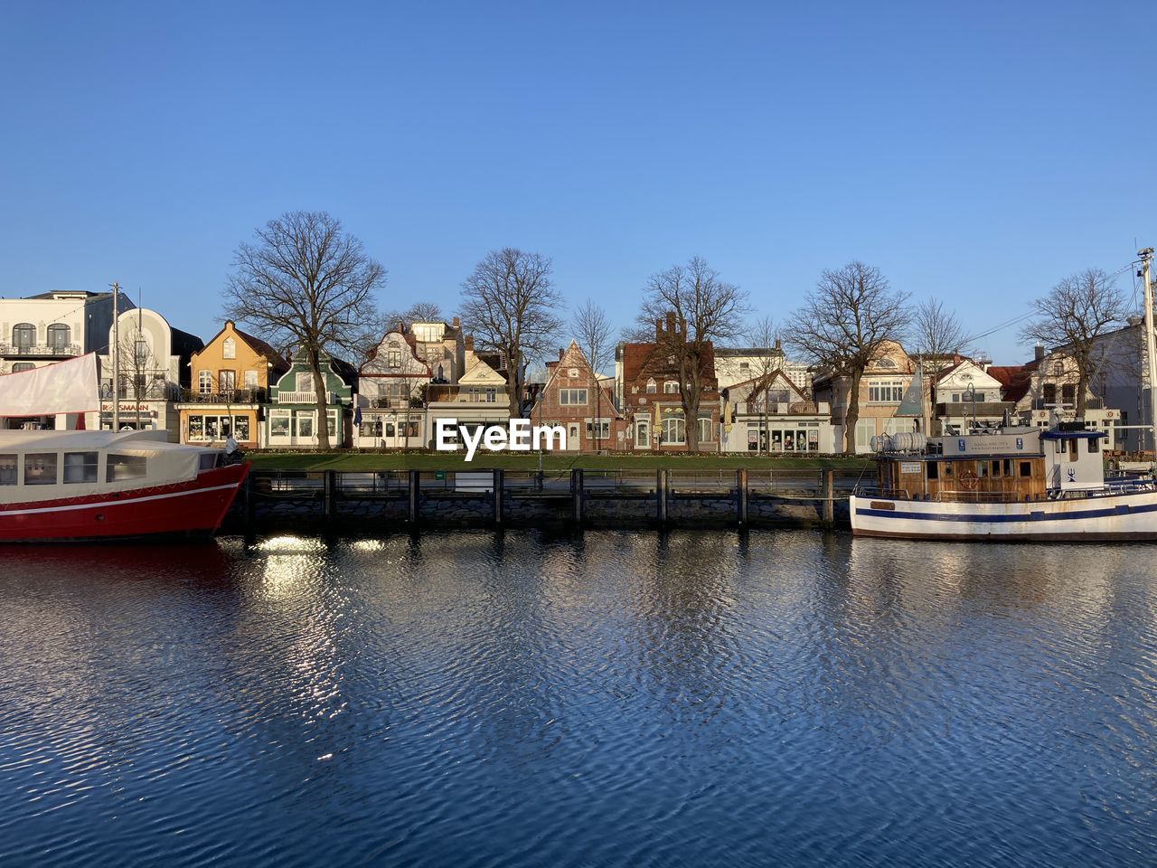 RIVER BY BUILDINGS AGAINST CLEAR SKY