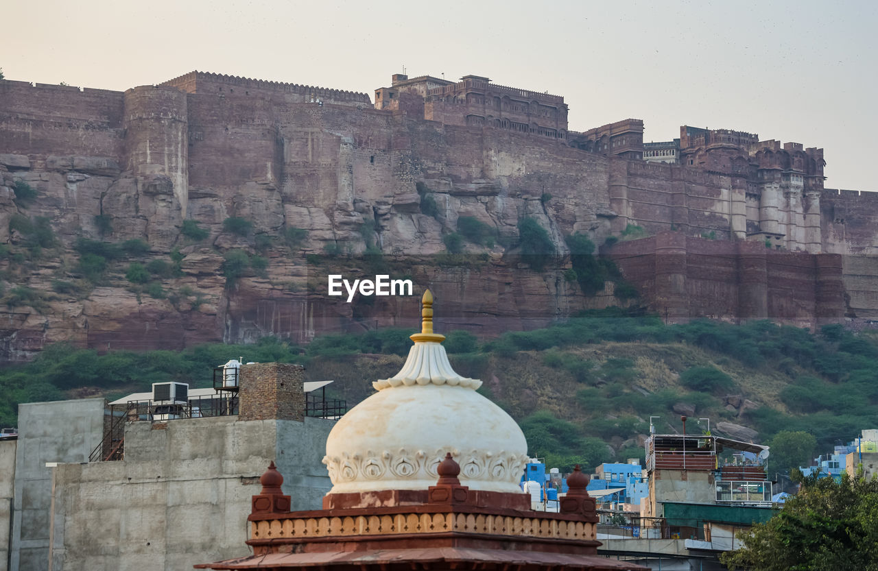 City construction with ancient fort background at day form flat angle