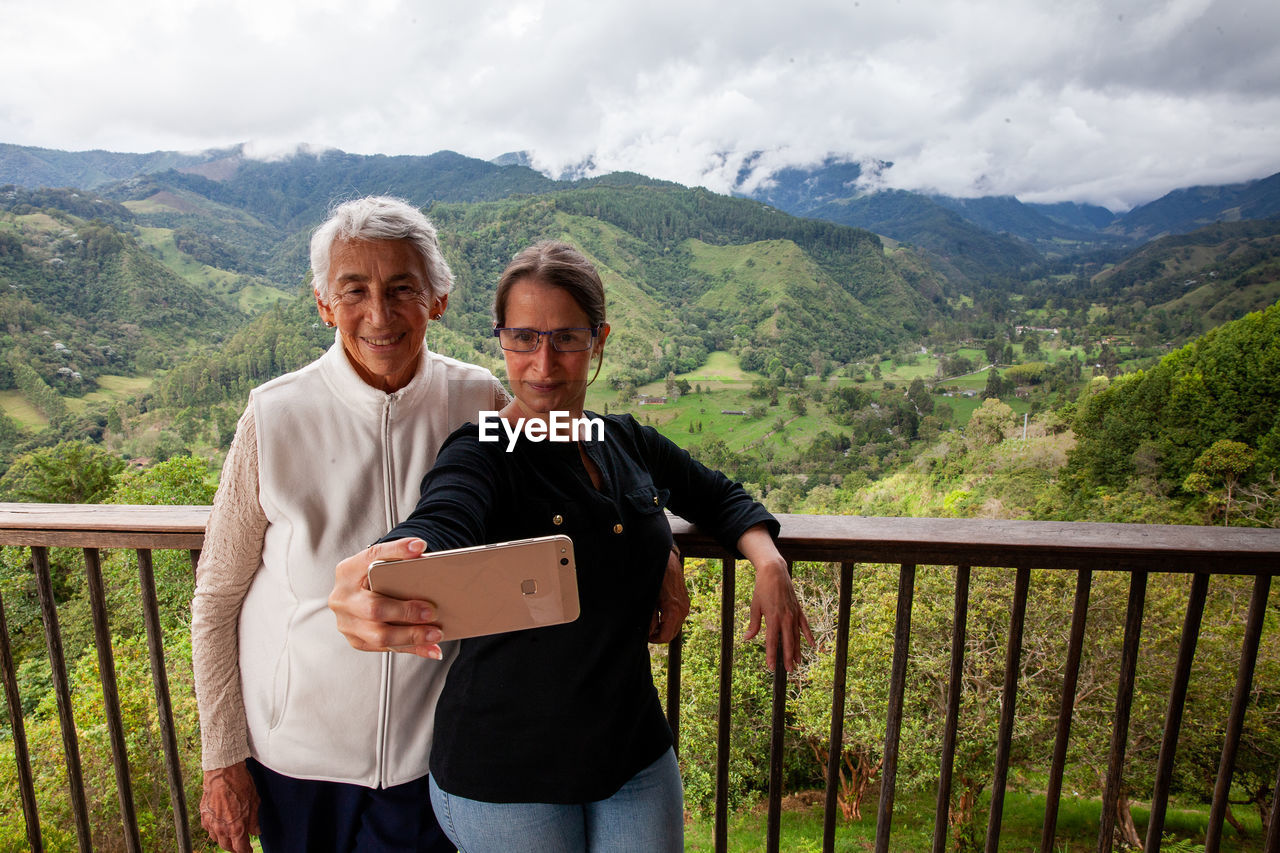 Senior mother and adult daughter traveling at the  view point over the cocora valley at salento