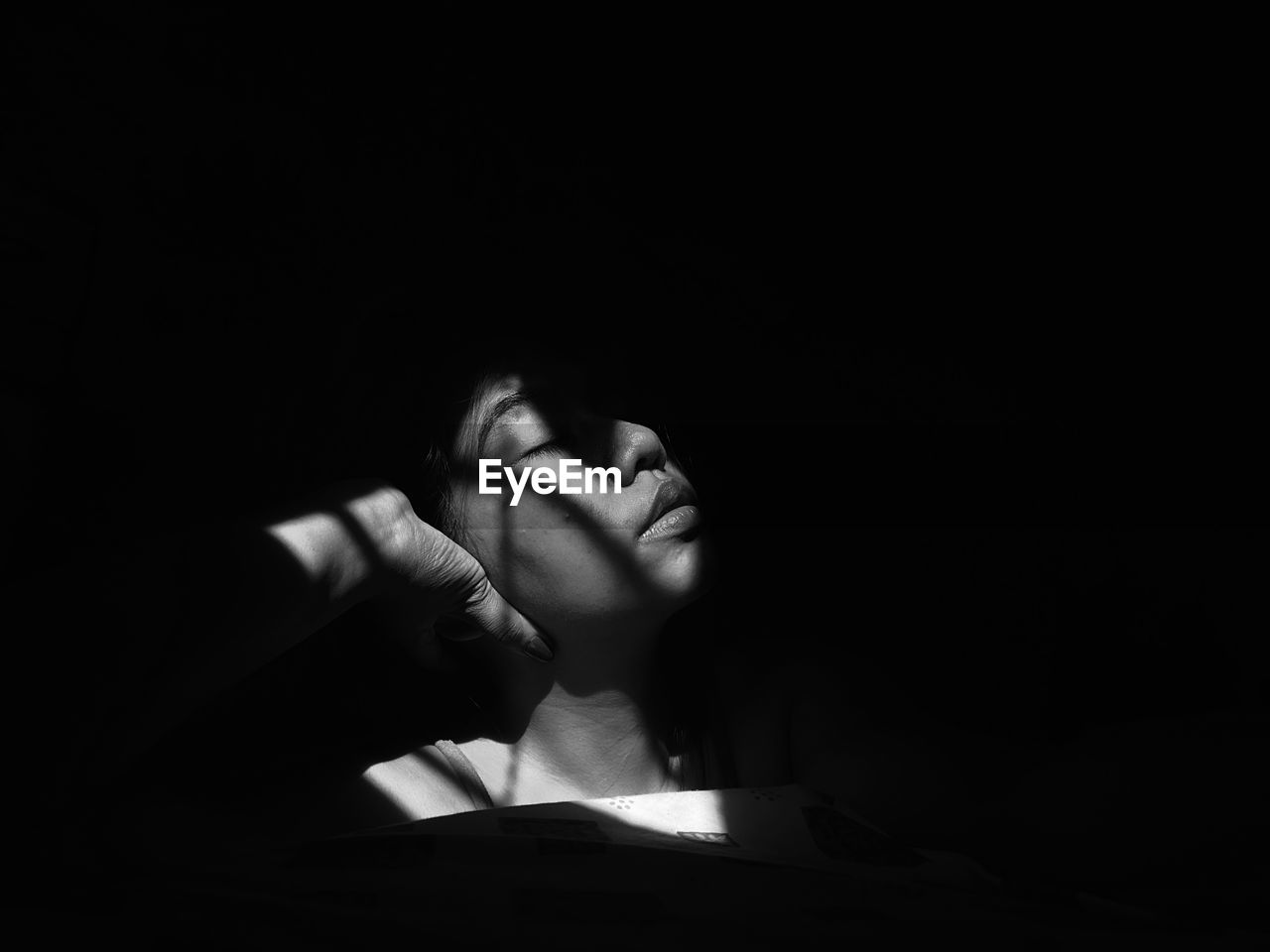 Close-up of young woman in darkroom