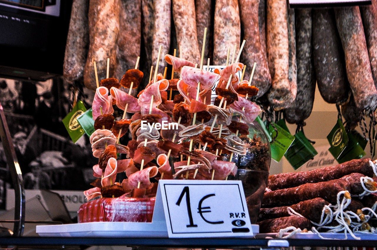 Close-up of meat in skewer with label at market stall