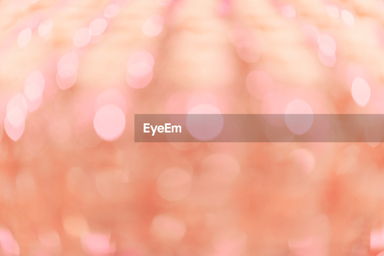 Defocused background of pink  peach colour light bokeh