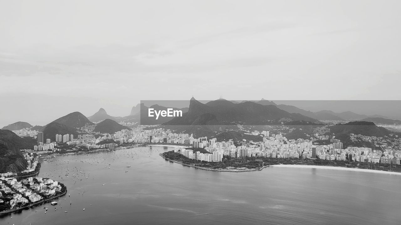 Scenic view of mountains against sky and city